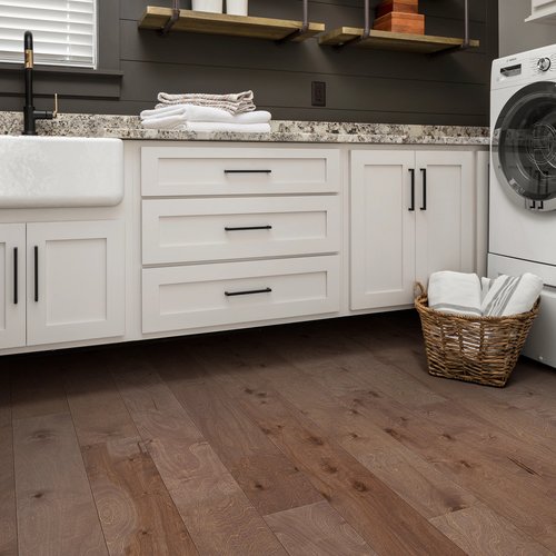 Kitchen with basket of laundry on hardwood flooring from Perkins Carpet Co in Conroe, TX