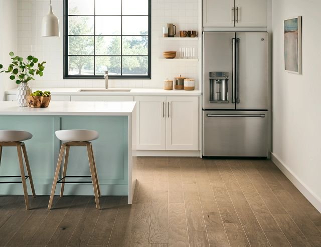 large modern kitchen with white bar top and bar stools from Perkins Carpet Co in Conroe, TX