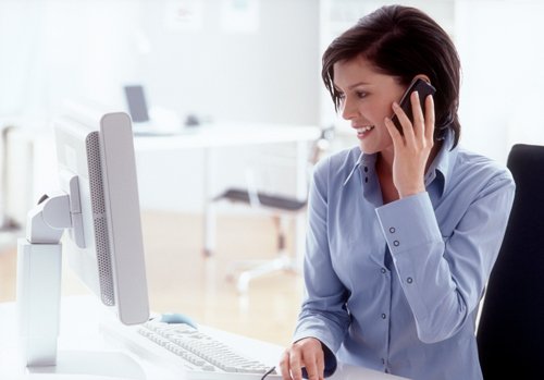 Office worker on phone from Perkins Carpet Co in Conroe, TX